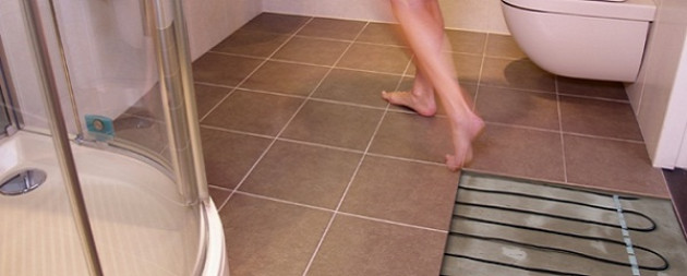Как сделать в ванной теплый пол под плитку: технология укладки и полезные советы